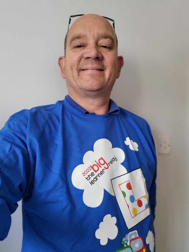 craig Jones, standing with Big Learner relay 2022 jumper on supporting the charity